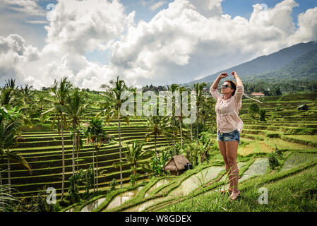 Beautiful  woman looking at beautiful tegallalang rice terrace in Bali, Indonesia Stock Photo
