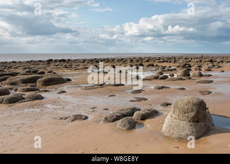 Distinctive large boulders in formation across the sandy beach of Hunstanton, Norfolk Stock Photo