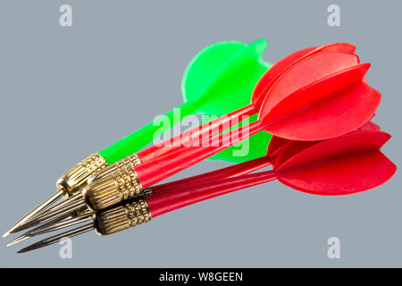 Red and green darts on a mirror background. Hit the target. Stock Photo