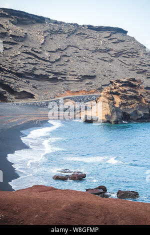 Between volcanic land and sea in El Golfo on the island of Lanzarote - Canary islands Stock Photo