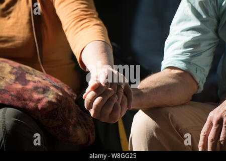 Close up of a man and woman holding hands Stock Photo