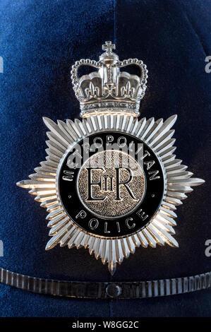 Metropolitan Police helmet badge crest close detail in shaft of sunlight Westminster London UK POLICE AUTHORITY BADGE CREST HELMET OFFICER CONSTABLE BRITISH UK Stock Photo