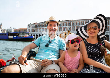 Happy Family On Vacation Sailing In Gondola, Venice Stock Photo