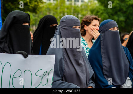A woman with uncovered face takes part during the protest.Hundreds of people gathered in The Hague after The Netherlands approves a limited ban on 'face-covering clothing', this law includes also niqabs and burqas. The demonstration was in silence to show their solidarity with women wearing niqabs. The Netherlands is the sixth EU country to prohibit face-covering clothing in public buildings. Stock Photo