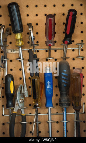 Screwdrivers in a workshop hanging on a pegboard Stock Photo