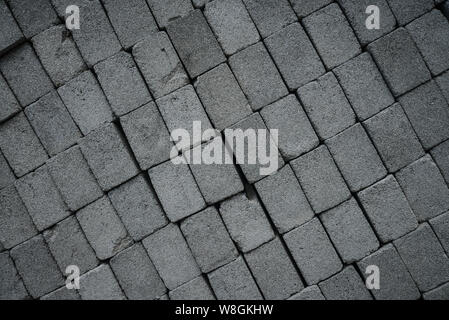 Stack of gray construction bricks closeup. May be used as background Stock Photo