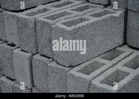 Stack of gray construction bricks closeup. May be used as background Stock Photo