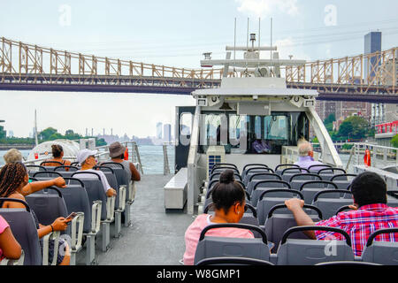 NYC East River Ferry on East river and skyline of New York at sunset. New York City, USA. Stock Photo