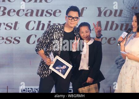 South Korean singer Jeong Soon-won, left, better known by his stage name The One, poses with a fan during a press conference for his Chinese album 'Be Stock Photo