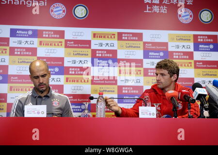 Head coach Pep Guardiola, left, of of Bayern Munich speaks next to Thomas Muller at a press conference for the upcoming friendly soccer match against