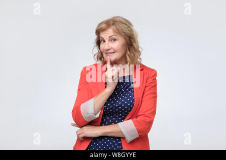 Mature caucasian woman thinking about something making plans about future. Stock Photo