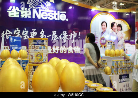 --FILE--A visitor is seen at the stand of Nestle during an exhibition in Fuzhou city, southeast China's Fujian province, 30 May 2014.   Swiss firm Nes Stock Photo