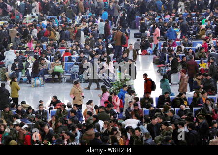 Chinese passengers crowd the Hangzhou East Railway Station as they wait for trains to go back home for Spring Festival to celebrate the Chinese Lunar Stock Photo