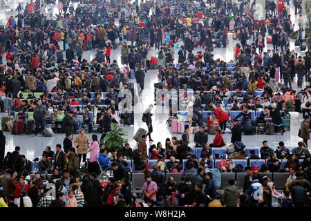 Chinese passengers crowd the Hangzhou East Railway Station as they wait for trains to go back home for Spring Festival to celebrate the Chinese Lunar Stock Photo