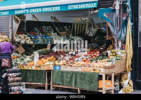 London, UK - July 16, 2019: Fruits and vegetables on sale ar Danys Green Grocers at Brixton Market, a community market run by local traders in the cen Stock Photo