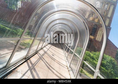 Soundproofing tunnel, plastic fence. Modern transparent noise protection in city downtown. Stock Photo