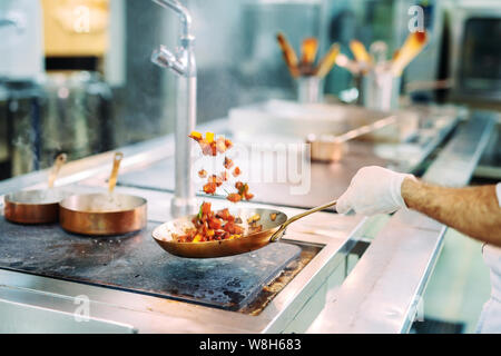 Chef cooking vegetables in wok pan. Shallow dof. Stock Photo