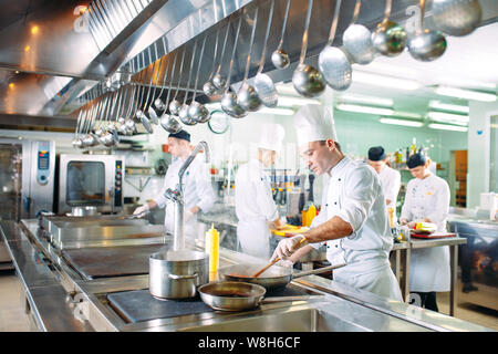 Modern kitchen. The chefs prepare meals in the restaurant's kitchen. Stock Photo