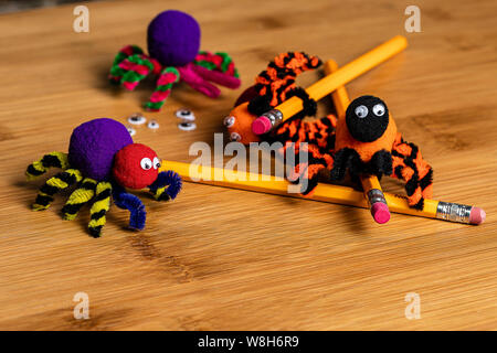 Fun Halloween Crafts.  Spiders made of pom poms and pipe cleaners.  Attach to pencils.  Family and kids crafts for fun together. Stock Photo