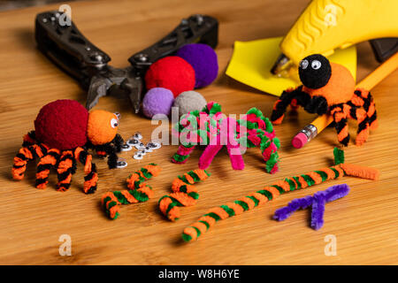 Fun Halloween Crafts.  Spiders made of pom poms and pipe cleaners.  Attach to pencils.  Family and kids crafts for fun together. Stock Photo