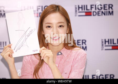 Singer and actress Goo Ha-ra, also known as Koo Ha-ra, of South Korean girl group Kara, shows her signature at a signing event for Tommy Hilfiger Deni Stock Photo