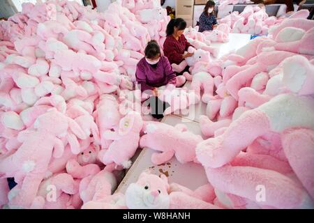 --FILE--Female Chinese workers sew stuffed toys to be exported to Europe and the United States at a garment factory in Ganyu Economic Development Area Stock Photo