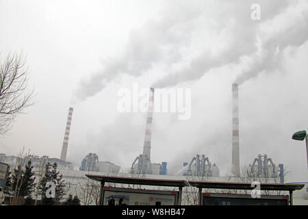 --FILE--Smoke is discharged from chimneys at a coal-fired power plant in Changchun city, northeast China's Jilin province, 25 January 2014.  China wil Stock Photo
