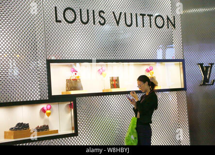 FILE--A pedestrian walks past a Louis Vuitton (LV) boutique of LVMH Moet Hennessy  Louis Vuitton SA in Fuzhou city, southeast Chinas Fujian province Stock  Photo - Alamy