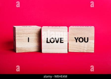 Message 'I love you spelled' in wooden blocks on pink background Stock Photo
