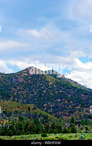 An image of green mountains under the cloudy sky Stock Photo - Alamy