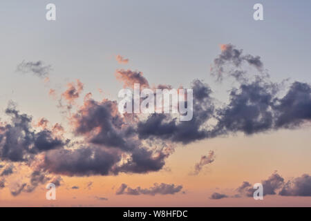 Beautiful sunset sky with bright multi-colored cumulus clouds with dramatic light, natural pastel colours Stock Photo