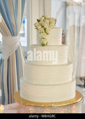 Multi-Tiered Wedding Cake with White Roses Stock Photo