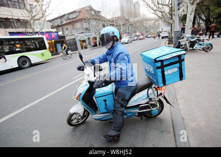 FILE A deliveryman of Chinese food delivery company Ele.me rides an electric bike to deliver meals in Shanghai China 24 March 2015. As China s e Stock Photo Alamy