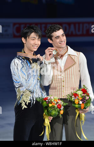 Gold medalist Javier Fernandez of Spain, right, and silver medalist Yuzuru Hanyu of Japan show their medals during the Men victory ceremony of the ISU Stock Photo