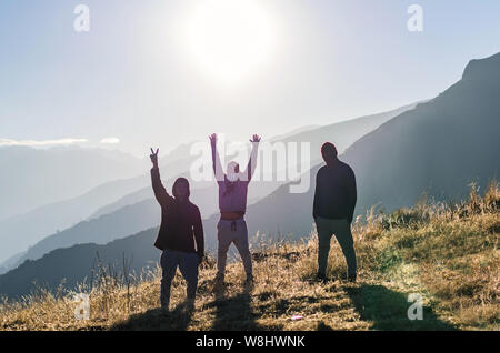 Three happy friends are looking on mountains and having fun together. Space for text. Travel concept. Archaeological zone of Chiprac - north of Lima - Peru Stock Photo