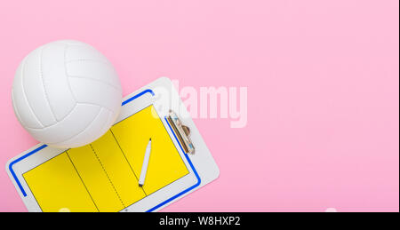 Volleyball and tactical board with marker on pink background. Top view Stock Photo