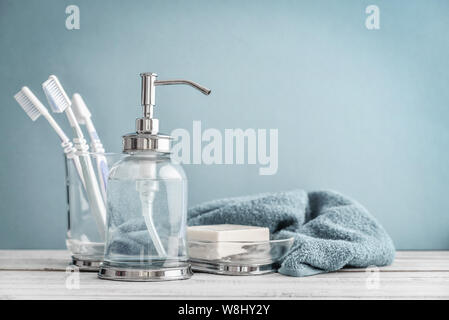 Bathroom set with toothbrushes, towel and soap on blue background Stock Photo