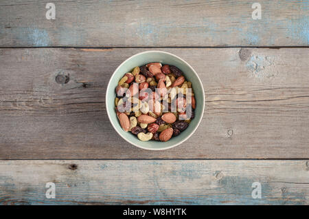 Mix nuts in bowl on wooden background, top view Stock Photo