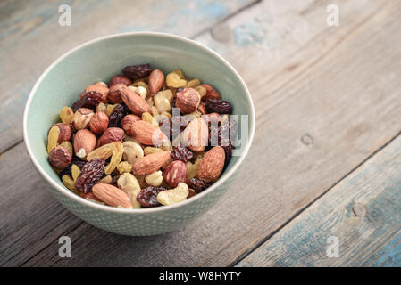 Mix nuts in bowl on wooden background closeup Stock Photo