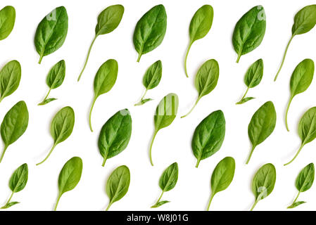 Spinach leaves on white background. Pattern made of spinach. Flat lay, top view Stock Photo