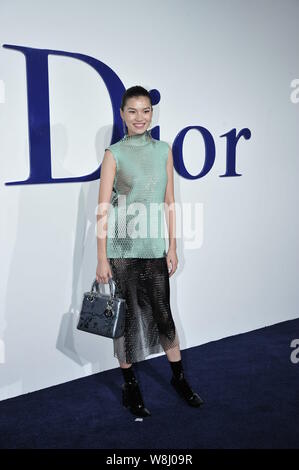 Chinese model and actress Daniella Wang poses as she arrives at the