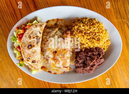 Chicken Enchilada plate with rice, beans and chicken taco Stock Photo