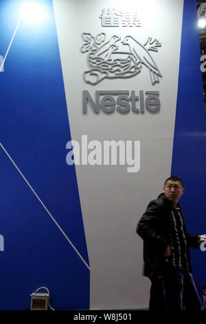 --FILE--A visitor is seen at the stand of Nestle during an exhibition in Beijing, China, 10 October 2012.   Swiss firm Nestle, the world's largest foo Stock Photo