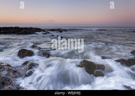 Westward Ho! seascape sunset with waves crashing around the rocks Stock Photo