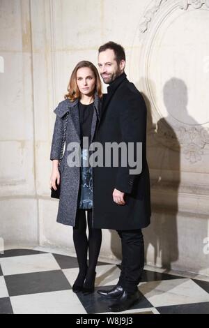 Israeli-born American actress Natalie Portman, left, and her husband Benjamin Millepied pose at the Christian Dior fashion show during the Paris Haute Stock Photo