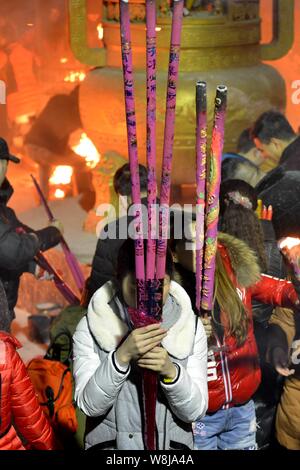 Worshippers pray at a temple on the eve of the Lunar New Year
