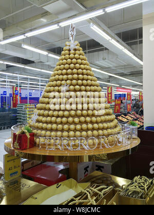 --FILE--A Christmas tree of Ferrero Rocher chocolate is displayed at a supermarket in Wuhan city, central China's Hubei province, 18 December 2014. Stock Photo