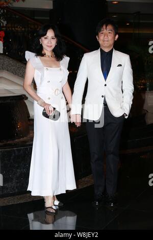 Hong Kong actress Carina Lau, left, and her actor husband Tony leung chiu wai, pose as they arrive for the wedding party of Hong Kong actor Kenny Bee Stock Photo