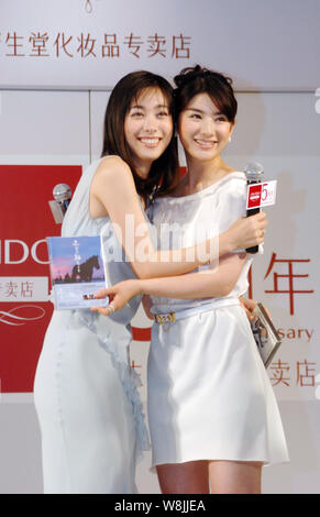 --FILE--Japanese actress Kazue Fukiishi, left, and Chinese actress Huang Yi pose at a promotional event for Shiseido cosmetics and skincare products i Stock Photo