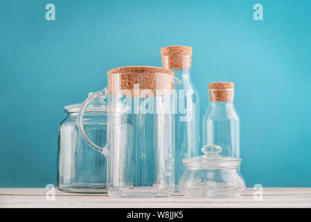 Glass kitchen utensils on blue background closeup Stock Photo